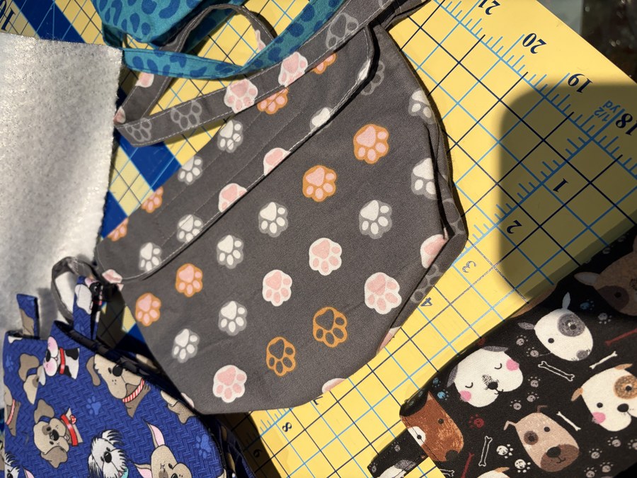 Process — charcoal paw-print pouch on the mat